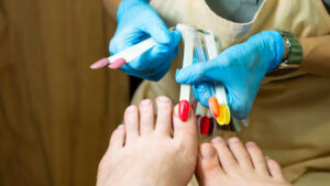 Pedicure. Color selection before color coating. Ðaster offers client set tips with different colors to choose from